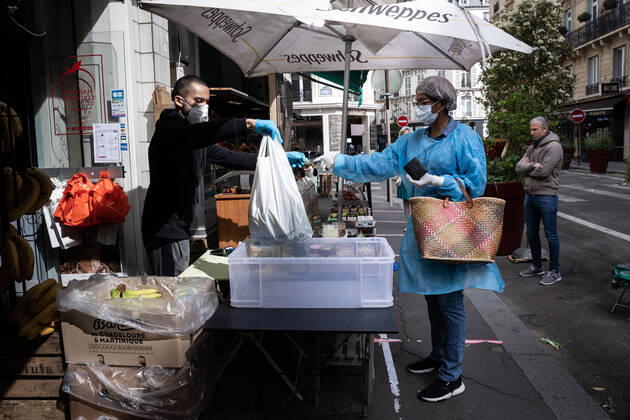 Paris, France, April 21, 2020 - Mrs. D., in her eighties, has just spent a dozen days in hospital after being infected with Coronavirus (Covid-19). Cured, she was able to return home, where Michele, a life assistant from the Neotine agency, goes several times a week to help her in her daily life - Michele does some shopping at the market to prepare lunch.  Copyright: xAlexisxSciardx
