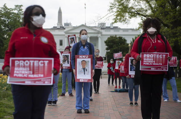 Nurses hold photos of fellow healthcare workers who have died from COVID-19 during a protest calling attention on healthcare infections nationwide and demanding the Trump administration to provide extra PPE for healthcare workers during the coronavirus pandemic, at the White House in Washington, D.C. on Tuesday, April 21, 2020.  WAP20200421322 KEVINxDIETSCH