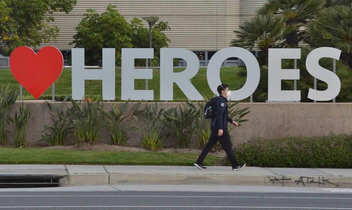 A nurse at the UC Irvine Medical Center walks to his car in Irvine, California on Monday, April 20, 2020. A group of some thirty nurses held a candlelight vigil after their shift change to call attention to healthcare workers nationwide who have been infected with COVID-19 and demanding the Trump administration provide N95 masks and extra PPE for healthcare workers during the coronavirus pandemic.  LAP2020042007 JIMxRUYMEN