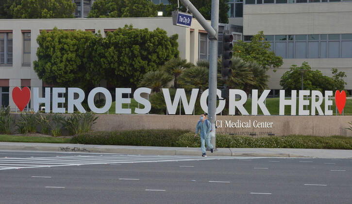 A registered nurse at UC Irvine Medical Center walks to his car in Irvine, California on Monday, April 20, 2020. Nurses held a candlelight vigil after their shift change to call attention to healthcare workers nationwide who have been infected with COVID-19 and demanding the Trump administration provide N95 masks and extra PPE for healthcare workers during the coronavirus pandemic.  LAP2020042008 JIMxRUYMEN