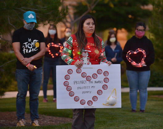 Registered nurses at the UC Irvine Medical Center hold a candlelight vigil after their shift change to call attention to healthcare workers nationwide who have been infected with COVID-19 and demanding the Trump administration provide N95 masks and extra PPE for healthcare workers during the coronavirus pandemic in Irvine, California on Monday, April 20, 2020.  LAP2020042002 JIMxRUYMEN