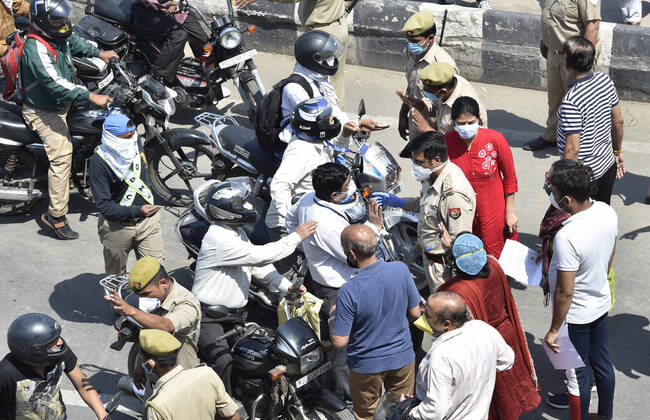 NEW DELHI, INDIA - APRIL 21: People show their papers to police personnel for passage at the Delhi-UP border in Ghazipur which was stopped by Ghaziabad administration during lockdown against coronavirus on April 21, 2020 in New Delhi, India. The orders to seal the Ghaziabad borders were issued by District Magistrate Ajay Shankar Pandey on Monday, but many people were unaware of the directive. The decision was taken after six people who had come from Delhi tested positive for coronavirus, said Pandey in an order issued on April 20. (Photo by Ajay Aggarwal Hindustan Times) Major Traffic Jam As Delhi-Ghaziabad Border Shut By District Magistrate To Stop Covid-19 Spread
