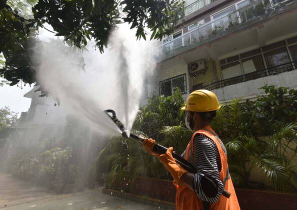 NEW DELHI, INDIA - APRIL 21: An Delhi Jal Board (DJB) worker chemically disinfects a house in Vasant Kunj during lockdown to curb the spread of coronavirus, on April 21, 2020 in New Delhi, India. (Photo by Sanjeev Verma Hindustan Times) Sanitization Drive To Curb The Spread Of Coronavirus COVID-19