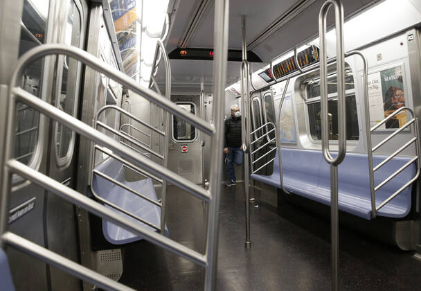 A man wearing a protective face mask rides on an F train subway car in New York City on Tuesday, April 21, 2020. An estimated 2.5 million people have been infected with the new coronavirus globally and It has killed more than 171,000 people worldwide. About 25% of those deaths have been recorded in the United States.  NYP20200421101 JOHNxANGELILLO