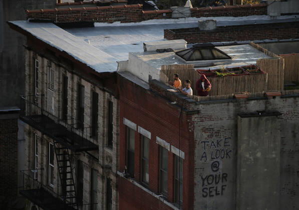 Four men applaud and make noise as they stand on the roof of a building in the East Village section of Manhattan for the 7pm moment salute to medical staff and essential workers in New York City on Tuesday, April 21, 2020. An estimated 2.5 million people have been infected with the new coronavirus globally and It has killed more than 171,000 people worldwide. About 25% of those deaths have been recorded in the United States.  NYP20200421120 JOHNxANGELILLO