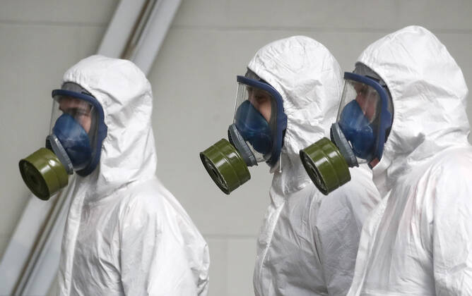 MOSCOW, RUSSIA - APRIL 22, 2020: Emercom workers in protective suits and gas masks carry out disinfection procedures at Kiyevsky railway station amid the ongoing COVID-19 pandemic. Sergei Fadeichev TASS  TS0D6A3C