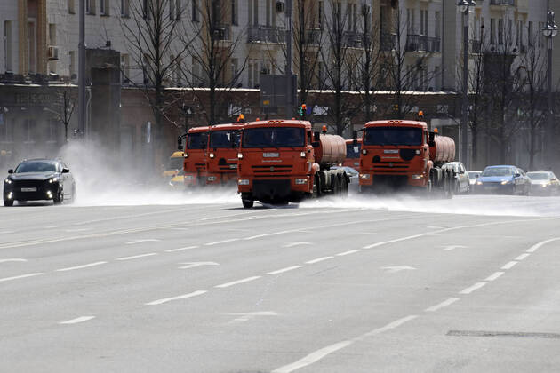 MOSCOW, RUSSIA - APRIL 22, 2020: Trucks wash the road with disinfectant on Tverskaya Street amid the ongoing COVID-19 pandemic; the Russian government has extended a paid period off work until April 30 nationwide to counter the spread of the COVID-19 infection. Mikhail Metzel TASS  TS0D6A44