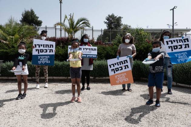 April 22, 2020, Jerusalem, Israel: Children with empty plates beg for food as African asylum seekers, a community of 31,000, stage a Ã¢â‚¬ËœGive Back Our MoneyÃ¢â‚¬â ¢ protest outside the Israeli parliament demanding wages confiscated by government be released immediately. Since 2017 the state has deducted 20% of asylum seekersÃ¢â‚¬â ¢ wages depositing them into accounts withdrawable only upon leaving the country or obtaining legal refugee status. The Coronavirus pandemic has left them with no income and no government assistance. Asylum seekers claim their socioeconomic situation was miserable to begin with and are now, in the COVID-19 crisis, on the brink of starvation and homelessness. Jerusalem Israel - ZUMAa126 20200422_zap_a126_014 Copyright: xNirxAlonx