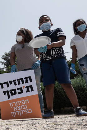 April 22, 2020, Jerusalem, Israel: Children with empty plates beg for food as African asylum seekers, a community of 31,000, stage a Ã¢â‚¬ËœGive Back Our MoneyÃ¢â‚¬â ¢ protest outside the Israeli parliament demanding wages confiscated by government be released immediately. Since 2017 the state has deducted 20% of asylum seekersÃ¢â‚¬â ¢ wages depositing them into accounts withdrawable only upon leaving the country or obtaining legal refugee status. The Coronavirus pandemic has left them with no income and no government assistance. Asylum seekers claim their socioeconomic situation was miserable to begin with and are now, in the COVID-19 crisis, on the brink of starvation and homelessness. Jerusalem Israel - ZUMAa126 20200422_zap_a126_017 Copyright: xNirxAlonx