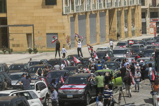 April 22, 2020, Beirut, Lebanon: Protesters wearing protective masks demonstrate in Martyr s Square, Beirut in a convoy of cars with drivers honking their horns, waving the Lebanese national flag and leaning out of the car windows to protest against the deteriorating living conditions exacerbated since the government imposed lockdown measures to combat the spread of COVID-19 coronavirus..Where: Beirut, Lebanon.When: 22 Apr 2020.Credit: Amer GhazzalCover Images Beirut Lebanon - ZUMAc218 20200422_zia_c218_008 Copyright: xCOVERxImagesx