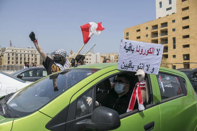 April 22, 2020, Beirut, Lebanon: Protesters wearing protective masks demonstrate in Martyr s Square, Beirut in a convoy of cars with drivers honking their horns, waving the Lebanese national flag and leaning out of the car windows to protest against the deteriorating living conditions exacerbated since the government imposed lockdown measures to combat the spread of COVID-19 coronavirus..Where: Beirut, Lebanon.When: 22 Apr 2020.Credit: Amer GhazzalCover Images Beirut Lebanon - ZUMAc218 20200422_zia_c218_024 Copyright: xCOVERxImagesx
