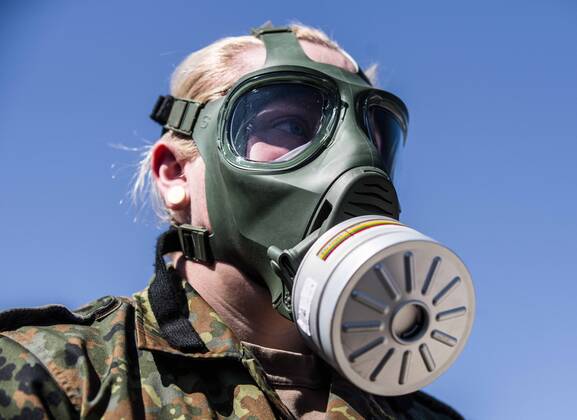 April 22, 2020, Neubiberg Bei Muenchen, Bavaria, Germany: German Bundeswehr soldiers wear gas masks and Dupint TyChem C protective clothing while mixing the constituents together to make Oxicide, a surface disinfectant used in the fight against Coronavirus. At the Bundeswehr Universitaet (Military University of Germany) in Neubiberg near Munich, Bavarian Interior Minister Joachim Herrmann, Generalleutnant Martin Schelleis, dem Nationalen Territorialen Befehlshaber und Inspekteur der Streitkro¤ftebasis, as well as members of the Technisches Hilfswerk (Federal Agency for Technical Relief) were on hand to explain the effort and coordination of the production of large amounts of surface disinfectants used to help in the fight against SARS-CoV-2 Coronavirus. Germany is currently at 148,174 positive diagnoses with 4,961 deaths. Neubiberg Be - ZUMAb160 20200422_zbp_b160_031 Copyright: xSachellexBabbarx