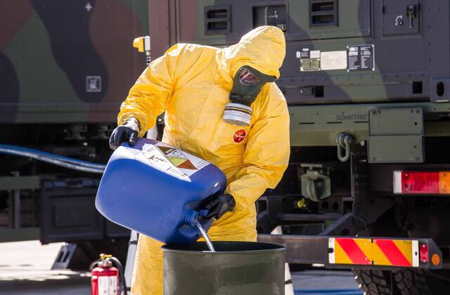 April 22, 2020, Neubiberg Bei Muenchen, Bavaria, Germany: German Bundeswehr soldiers wear gas masks and Dupint TyChem C protective clothing while mixing the constituents together to make Oxicide, a surface disinfectant used in the fight against Coronavirus. At the Bundeswehr Universitaet (Military University of Germany) in Neubiberg near Munich, Bavarian Interior Minister Joachim Herrmann, Generalleutnant Martin Schelleis, dem Nationalen Territorialen Befehlshaber und Inspekteur der Streitkro¤ftebasis, as well as members of the Technisches Hilfswerk (Federal Agency for Technical Relief) were on hand to explain the effort and coordination of the production of large amounts of surface disinfectants used to help in the fight against SARS-CoV-2 Coronavirus. Germany is currently at 148,174 positive diagnoses with 4,961 deaths. Neubiberg Be - ZUMAb160 20200422_zbp_b160_043 Copyright: xSachellexBabbarx