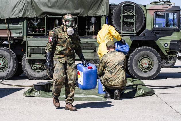 April 22, 2020, Neubiberg Bei Muenchen, Bavaria, Germany: German Bundeswehr soldiers wear gas masks and Dupint TyChem C protective clothing while mixing the constituents together to make Oxicide, a surface disinfectant used in the fight against Coronavirus. At the Bundeswehr Universitaet (Military University of Germany) in Neubiberg near Munich, Bavarian Interior Minister Joachim Herrmann, Generalleutnant Martin Schelleis, dem Nationalen Territorialen Befehlshaber und Inspekteur der Streitkro¤ftebasis, as well as members of the Technisches Hilfswerk (Federal Agency for Technical Relief) were on hand to explain the effort and coordination of the production of large amounts of surface disinfectants used to help in the fight against SARS-CoV-2 Coronavirus. Germany is currently at 148,174 positive diagnoses with 4,961 deaths. Neubiberg Be - ZUMAb160 20200422_zbp_b160_045 Copyright: xSachellexBabbarx