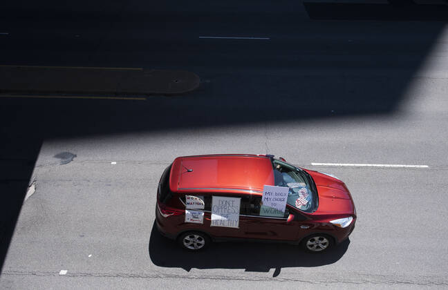 Protesters demonstrate from the vehicles as they call on Gov. Ralph Northam to reopen Virginia and end executive order 53 with bans gatherings of over 10 in the midst of the Coronavirus COVID-19 pandemic, near the State Capitol Building in Richmond, Virginia on Wednesday, April 22, 2020. The group is urging the reopening of business despite the COVID-19 pandemic still infecting the nation.  WAP20200422310 KEVINxDIETSCH