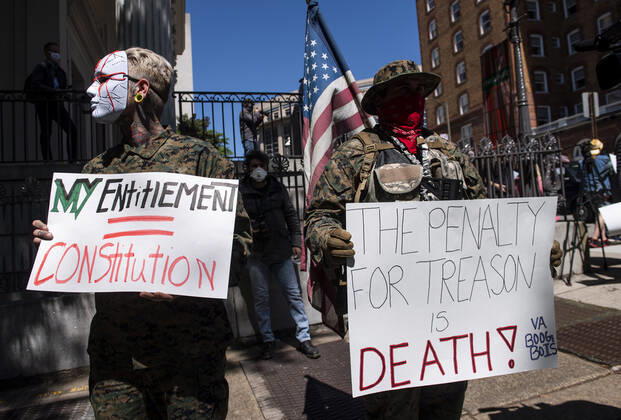 Protesters participate in a rally calling on Gov. Ralph Northam to reopen Virginia and end executive order 53 with bans gatherings of over 10 in the midst of the Coronavirus COVID-19 pandemic, near the State Capitol Building in Richmond, Virginia on Wednesday, April 22, 2020. The group is urging the reopening of business despite the COVID-19 pandemic still infecting the nation.  WAP20200422313 KEVINxDIETSCH