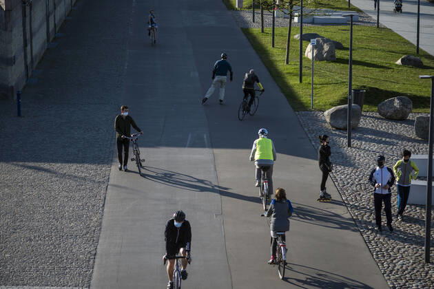 April 22, 2020, Warsaw, Mazowieckie, Poland: People wearing face masks as a precaution along a street during the Covid-19 pandemic..The Polish government softened some of the restrictions related to the Covid-19 pandemic. Citizens are now allowed to walk in parks, more customers are allowed to enter shops. Protective masks are still obligatory for every citizen in public space. Warsaw Poland - ZUMAs197 20200422_zaa_s197_099 Copyright: xAttilaxHusejnowx