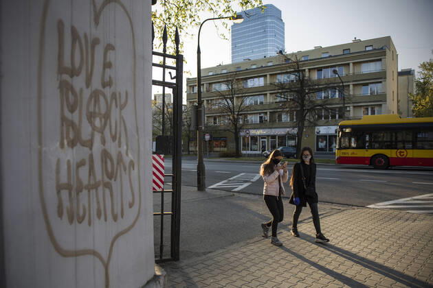 April 22, 2020, Warsaw, Mazowieckie, Poland: Women wearing face masks as a precaution walk along a deserted street during the Covid-19 pandemic..The Polish government softened some of the restrictions related to the Covid-19 pandemic. Citizens are now allowed to walk in parks, more customers are allowed to enter shops. Protective masks are still obligatory for every citizen in public space. Warsaw Poland - ZUMAs197 20200422_zaa_s197_105 Copyright: xAttilaxHusejnowx