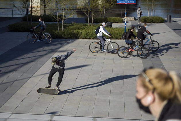 April 22, 2020, Warsaw, Mazowieckie, Poland: People cycling and skateboarding on the boulevard next to Vistula river during the Covid-19 pandemic..The Polish government softened some of the restrictions related to the Covid-19 pandemic. Citizens are now allowed to walk in parks, more customers are allowed to enter shops. Protective masks are still obligatory for every citizen in public space. Warsaw Poland - ZUMAs197 20200422_zaa_s197_108 Copyright: xAttilaxHusejnowx