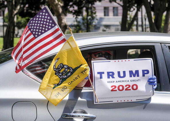 April 22, 2020, Los Angeles, California, U.S: A demonstrator in a car shows a sign during a vehicle caravan protest to call on state and local officials to re-open the economy during the coronavirus disease outbreak in downtown Los Angeles, Wednesday April 22, 2020. Los Angeles U.S. - ZUMAc68_ 20200422_zaf_c68_017 Copyright: xRingoxChiux