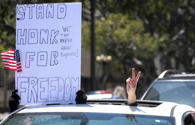 April 22, 2020, Los Angeles, California, U.S: Demonstrators take part a vehicle caravan protest to call on state and local officials to re-open the economy during the coronavirus disease outbreak in downtown Los Angeles, Wednesday April 22, 2020. Los Angeles U.S. - ZUMAc68_ 20200422_zaf_c68_032 Copyright: xRingoxChiux