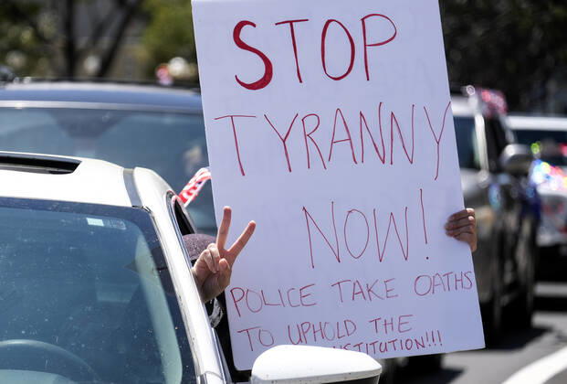 April 22, 2020, Los Angeles, California, U.S: Demonstrators take part a vehicle caravan protest to call on state and local officials to re-open the economy during the coronavirus disease outbreak in downtown Los Angeles, Wednesday April 22, 2020. Los Angeles U.S. - ZUMAc68_ 20200422_zaf_c68_033 Copyright: xRingoxChiux