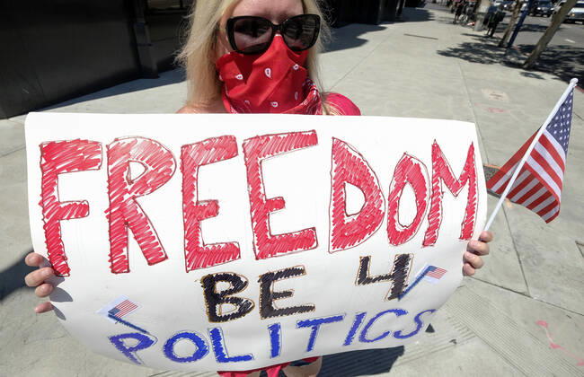 April 22, 2020, Los Angeles, California, U.S: A demonstrator wearing a face mask and holding a sign takes part a vehicle caravan protest to call on state and local officials to re-open the economy during the coronavirus disease outbreak in downtown Los Angeles, Wednesday April 22, 2020. Los Angeles U.S. - ZUMAc68_ 20200422_zaf_c68_040 Copyright: xRingoxChiux