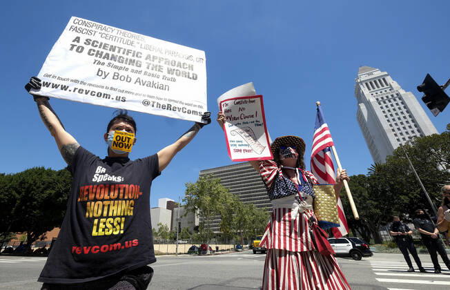 April 22, 2020, Los Angeles, California, U.S: Demonstrators wearing face masks argue opposing views during a vehicle caravan protest to call on state and local officials to re-open the economy during the coronavirus disease outbreak in downtown Los Angeles, Wednesday April 22, 2020. Los Angeles U.S. - ZUMAc68_ 20200422_zaf_c68_043 Copyright: xRingoxChiux