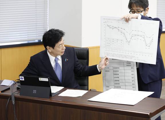 New coronavirus Japanese economic revitalization minister Yasutoshi Nishimura speaks during a videoconference with a group of governors from around the country to discuss measures against the new coronavirus on April 23, 2020, in Tokyo. 