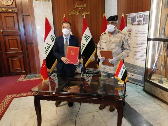 (200422) -- BAGHDAD, April 22, 2020 (Xinhua) -- Chinese Ambassador to Iraq Zhang Tao (L) and representative of Iraqi Ministry of Defense attend the medical aid handover ceremony in Baghdad, Iraq, April 22, 2020. Chinese Ambassador to Iraq Zhang Tao on Wednesday handed medical aid to Iraqi Ministry of Defense to fight COVID-19. (Xinhua) IRAQ-BAGHDAD-CHINA-MEDICAL AID 