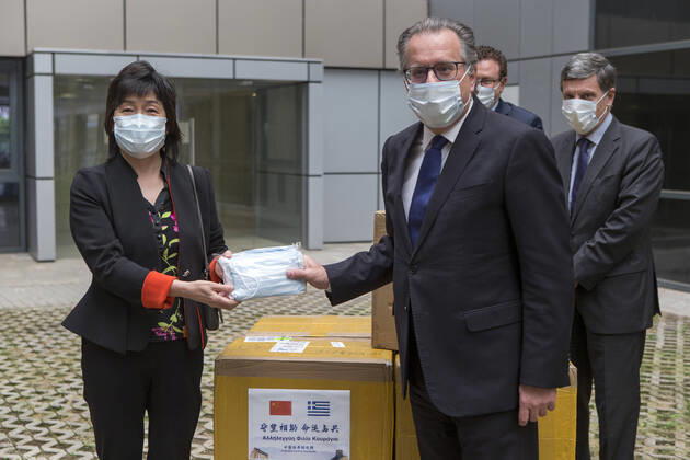 (200422) -- ATHENS, April 22, 2020 -- Chinese Ambassador to Greece Zhang Qiyue (L) and Greek Alternate Migration and Asylum Minister Giorgos Koumoutsakos (R, front) pose for a photo at the donation handover ceremony in Athens, Greece, on April 22, 2020. Greece welcomed on Wednesday the donation by China to help curb the spread of the novel coronavirus at hosting facilities, where thousands of refugees and migrants are accommodated. ) GREECE-ATHENS-CHINA-MASK DONATION-COVID-19 MariosxLolos 
