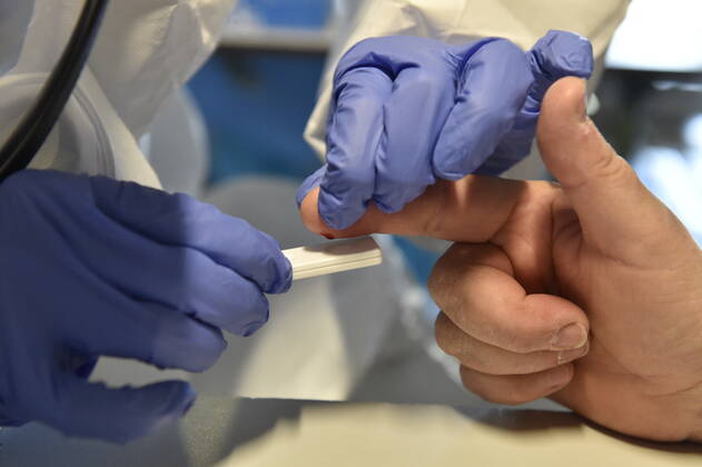 A medic takes a sample for a covid-19 test from a volunteer, on April 23, 2020, in Brno, Czech Republic. Across-the-board testing of population for new coronavirus began today. Test points open in Prague at 10:00, in Brno and Litomerice at 8:00. The goal is to find out the presence of coronavirus in Czech population. (CTKxPhoto VaclavxSalek) CTKPhotoP202004230203501 _SAL8316