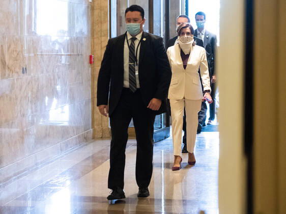 Speaker of the House Nancy Pelosi, D-Calif, wears a scarf as a mask to protect against COVID-19 as she arrives at the U.S. Capitol on Thursday, April 23, 2020. The House is expected to vote and pass a Coronavirus relief bill today.  WAP20200423305 KEVINxDIETSCH