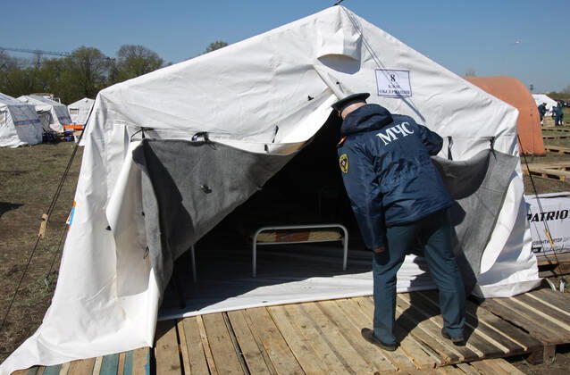 DONETSK, UKRAINE - APRIL 23, 2020: A serviceman of the Emergency Situations Ministry of the Donetsk People s Republic at a field hospital for coronavirus patients set up as part of a COVID-19 response exercise; the exercise is aimed at providing a timely and efficient professional medical assistance to victims of emergencies in case of a lack of beds in hospitals. A similar field hospital can admit over 100 people. Valentin Sprinchak TASS  TS0D6D32
