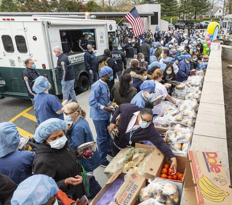 NYC Police Benevolent Association thanks staff Nurses, doctors and staff pick up food brought by NYC Police Benevolent Association to thank staff at LIJMC. President of NYC Police Benevolent Association Patrick Lynch joins dozens of NYC police officers to address LIJMC staff to thank them for their heroic work in battling the COVID crisis and present staff with 750 individually-wrapped sandwiches, fruits and bottle of water. More than 7,000 patients were successfully treated and released from this hospital in the past few weeks. New Hyde Park New York United States Copyright: LevxRadin
