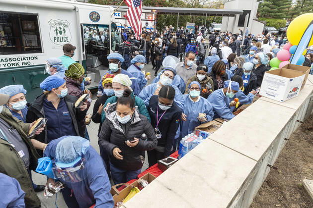 NYC Police Benevolent Association thanks staff Nurses, doctors and staff pick up food brought by NYC Police Benevolent Association to thank staff at LIJMC. President of NYC Police Benevolent Association Patrick Lynch joins dozens of NYC police officers to address LIJMC staff to thank them for their heroic work in battling the COVID crisis and present staff with 750 individually-wrapped sandwiches, fruits and bottle of water. More than 7,000 patients were successfully treated and released from this hospital in the past few weeks. New Hyde Park New York United States Copyright: LevxRadin