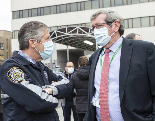 NYC Police Benevolent Association thanks staff CEO of Northwell Health Michael Dowling speaks with President of PBA Patrick Lynch during NYC Police Benevolent Association thanks staff at LIJMC. President of NYC Police Benevolent Association Patrick Lynch joins dozens of NYC police officers to address LIJMC staff to thank them for their heroic work in battling the COVID crisis and present staff with 750 individually-wrapped sandwiches, fruits and bottle of water. More than 7,000 patients were successfully treated and released from this hospital in the past few weeks. New Hyde Park New York United States Copyright: LevxRadin