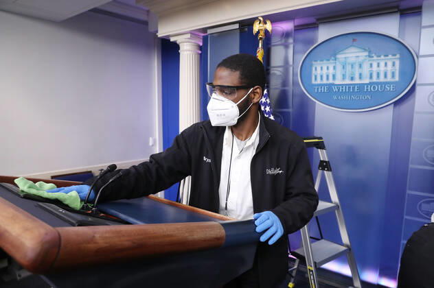 A worker sanitizes the podium before US President Donald J. Trump is joined by members of the Coronavirus Task Force to deliver remarks on the COVID-19 pandemic in the James S. Brady Press Briefing Room of the White House in Washington, DC, USA, 23 April 2020. Copyright: xMichaelxReynoldsx xPoolxviaxCNPx MediaPunchx