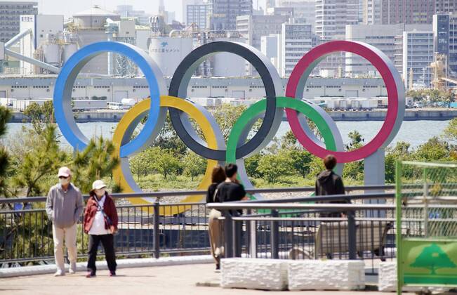 Olympic rings monument in Tokyo People walk near the Olympic rings in Tokyo s Odaiba waterfront area on April 23, 2020. The 2020 Tokyo Games have been postponed for about one year due to the coronavirus pandemic. 