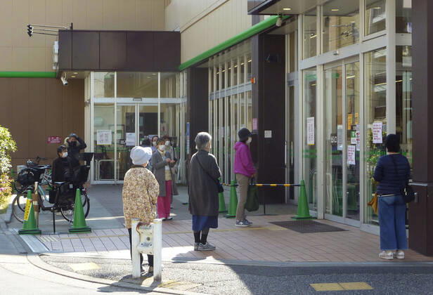 New coronavirus People observe social distancing in front of a supermarket in Tokyo as they wait for the store to open on April 24, 2020, amid the spread of the new coronavirus. Tokyo Gov. Yuriko Koike has requested residents limit their grocery store visits to once every three days as part of steps to prevent supermarkets from becoming overcrowded. 