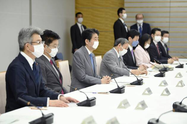 New coronavirus Japanese Prime Minister Shinzo Abe (3rd from L) attends a meeting of a coronavirus task force at his office in Tokyo on April 24, 2020. 