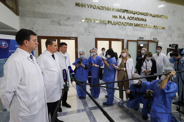 MOSCOW, RUSSIA - APRIL 24, 2020: Andrei Apolikhin, Head of Lopatkin Urology and Interventional Radiology Research Institute, Russia s Healthcare Minister Mikhail Murashko and Andrei Kaprin (L-R), General Director of the Russian National Medical Research Centre of Radiology, talk to journalists during a media scrum on their visit to a department of infectious diseases opened at Lopatkin Urology and Interventional Radiology Research Institute to treat COVI-19 patients. Sergei Savostyanov TASS  TS0D6F54