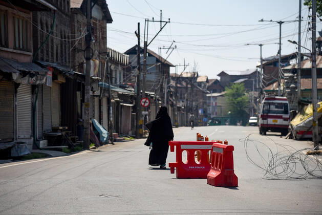 April 24, 2020, Srinagar, India: A burqa clad woman walks past barricades set up during the nationwide lockdown..India s Health Ministry has so far recorded a total 23,452 infections, death 272 and recovered 4,814 cases since the beginning of the corona virus outbreak. Srinagar India - ZUMAs197 20200424_zaa_s197_029 Copyright: xIdreesxAbbasx