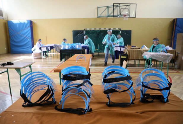 Members of the City Hall and volunteers produce face shields in one of the primary schools durng the coronavirus outbreak Members of the City Hall and volunteers produce face shields in one of the primary schools durng the coronavirus outbreak on April 24, 2020 in Otwock near Warsaw, Poland. EN_01426132_0027 