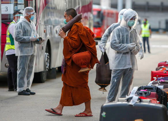 April 24, 2020, Bangkok, Thailand: A Buddhist monk wearing a face mask as a preventive measure arrives at Don Mueang International Airport during the Coronavirus (COVID-19) crisis..Thailand has so far reported 2,854 cases of COVID-19 coronavirus with most of the cases reported in the Capital city of Bangkok. Bangkok Thailand - ZUMAs197 20200424_zaa_s197_060 Copyright: xChaiwatxSubprasomx