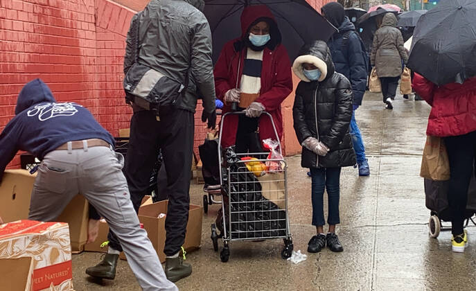 NEW YORK, NY- APRIL 24: New Yorkers line up in the Rain at food distribution point with paper bags donated by Staples at Roberto Clemente School during the coronavirus pandemic in West Harlem on April 24, 2020 in New York City. Copyright: xRainmakerxPhotos MediaPunchx