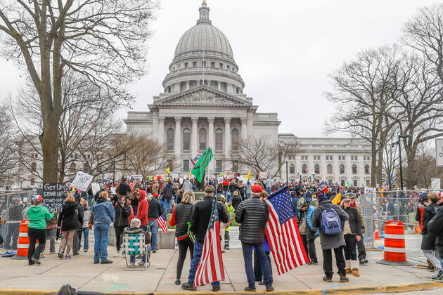 MADISON, WI - APRIL 24: At a Rally to Reopen Wisconsin , Safer at Home protesters demonstrate against measures enacted to mitigate the Coronavirus congregate close together to hear speeches on April 24, 2020 at the Wisconsin state Capitol in Madison, WI. (Photo by Lawrence Iles Icon Sportswire)