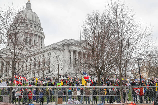 MADISON, WI - APRIL 24: At a Rally to Reopen Wisconsin , Safer at Home protesters demonstrate against measures enacted to mitigate the Coronavirus congregate close together to hear speeches on April 24, 2020 at the Wisconsin state Capitol in Madison, WI. (Photo by Lawrence Iles Icon Sportswire)