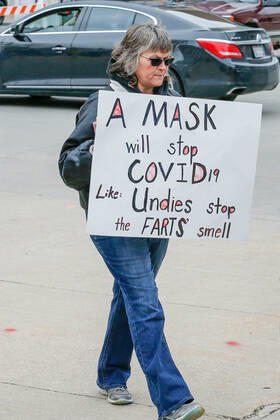 April 24, 2020, Madison, WI, USA: MADISON, WI - April 24: A lone protester carries a sign at a Rally to Reopen Wisconsin demonstrating against measures enacted to mitigate the corona virus on April 24, 2020 at the Wisconsin state Capitol in Madison, WI. ( Icon Sportswire) Madison USA - ZUMAi88_ 20200424_zaf_i88_018 Copyright: xLawrencexIlesx