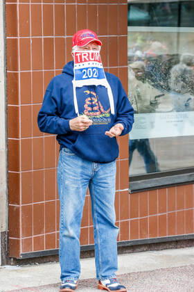 April 24, 2020, Madison, WI, USA: MADISON, WI - April 24: A protester uses a Trump flag as a mask at a Rally to Reopen Wisconsin demonstration against measures enacted to mitigate the corona virus on April 24, 2020 at the Wisconsin state Capitol in Madison, WI. ( Icon Sportswire) Madison USA - ZUMAi88_ 20200424_zaf_i88_013 Copyright: xLawrencexIlesx